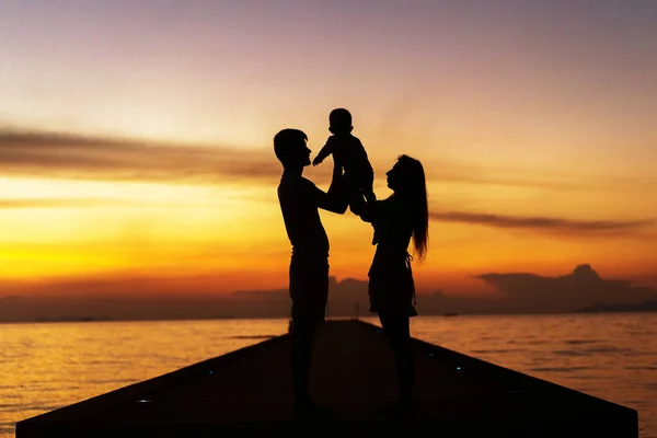 Family silhouette at sunset with son — Stock Photo, Image