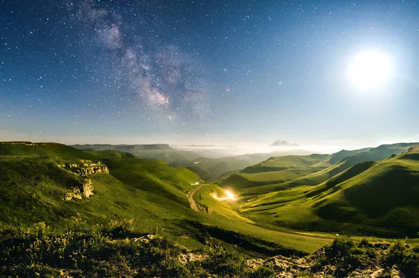 Green meadows under the stars and milky way