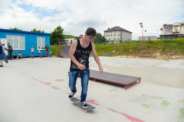 Skate park Pyatigorsk.Young Kafkas kaykaycılar açık beton skatepark sürme kaykay yarışmaya. Patenciler ödül için yarışmak... Genç kaykaycı çocuklar üzerinde paten rampası çevirmeye hazır