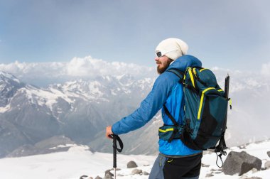 Şapka ve güneş gözlüğü takan bir sakallı rehber portresi