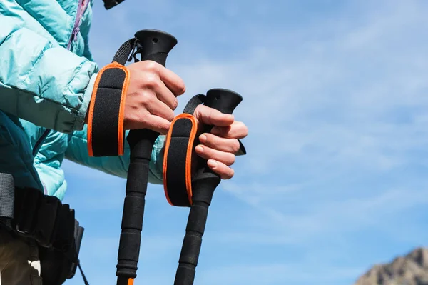 Detail ženských rukou s Trekingové hole pro Nordic walking na pozadí alpské jezero a daleké kavkazské skály — Stock fotografie