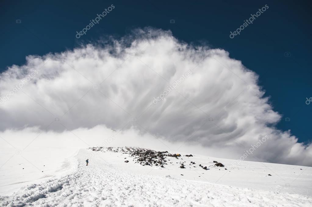 Stormy clouds overhang over the snow-capped mountain Elbrus