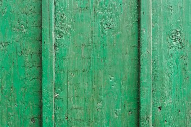 Doku yeşil ahşap bir yönetim kurulu. Bir çatırtı yeşil boya dikey ahşap kurullarında. Dikey paralel çizgiler