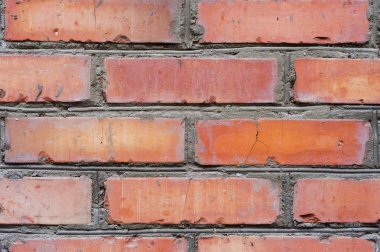 Dokulu arka plan kırmızı tuğla duvar izleri yaşlılık olan ve tuğla farklı tonları ile. Tuğla el ile eğri duvar ve farklı renk