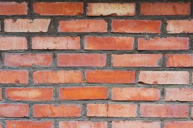 Dokulu arka plan kırmızı tuğla duvar izleri yaşlılık olan ve tuğla farklı tonları ile. Tuğla el ile eğri duvar ve farklı renk