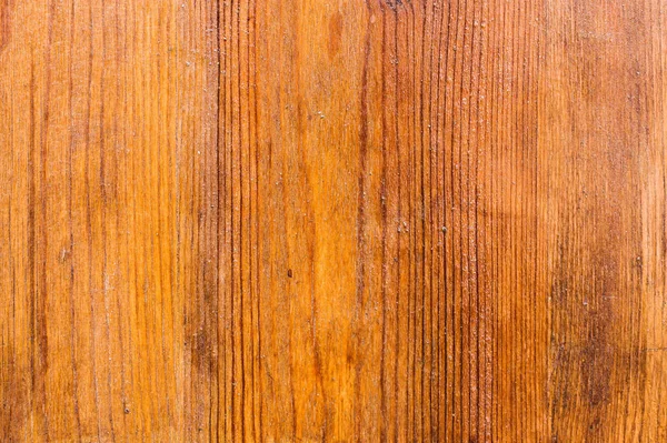 The background of the wooden varnished surface with the patterns of wood fibers appearing through the lacquer. Red wood. Aged wooden background structure — Stock Photo, Image
