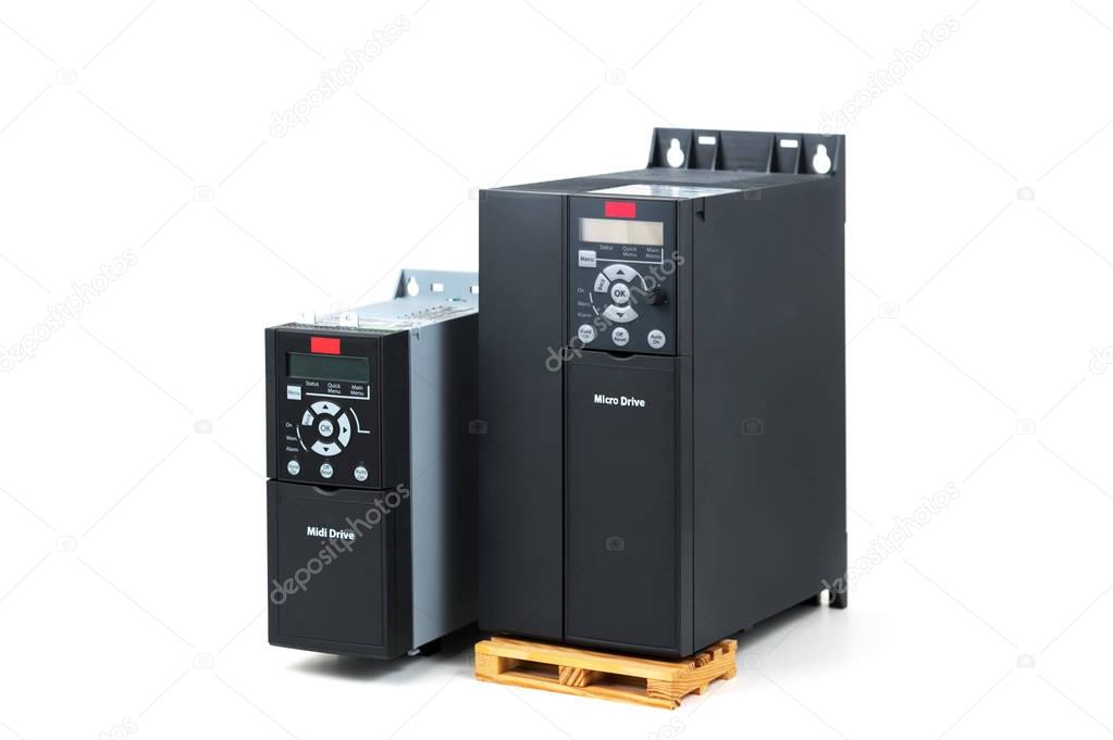 A group of two different sizes and capacities new universal inverter for controlling the electric current and power for industrial on a isolated white background. A frequency converter - rectifier -