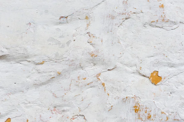 Grunge arka plan dokulu. Hacimsel duvar ile bir çok katmanlı kaplama kırık. Turuncu badanalı duvara fişleri. Doku derin bir desen ile