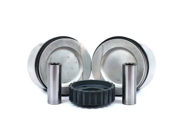Close-up of spare parts two new pistons with connecting rods for a gasoline engine with installed sets of piston rings and crankshaft sprocket on an isolated white background — Stock Photo, Image