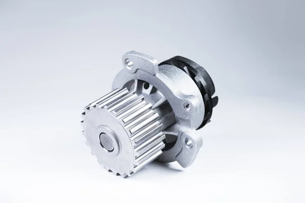 New metal automobile pump for cooling an engine water pump on a isolated white background. The concept of new spare parts for the car engine — Stock Photo, Image