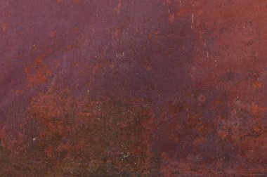 Bir zamanlar kırmızıya boyanmış paslı metal bir yüzey.