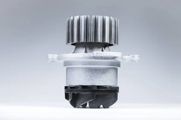 New metal automobile pump for cooling an engine water pump on a isolated white background. The concept of new spare parts for the car engine