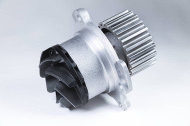 Bir degrade ile gri bir arka plan üzerinde bir motor su pompası soğutma için yeni metal otomobil pompası. Otomobil motoru için yeni yedek parça konsepti