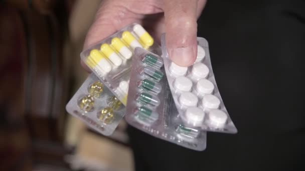 Nahaufnahme einer Tablette an den Händen einer alten Frau. das Konzept der Medikamentenwahl im Alter — Stockvideo