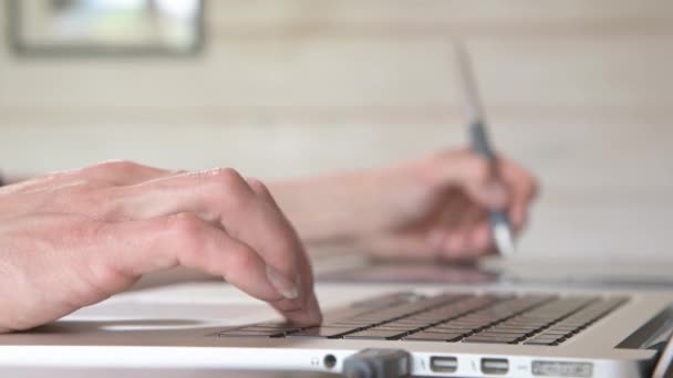 Close-up de um designer masculino desenha em seu laptop com a ajuda. comprimido gráfico e caneta caneta caneta — Vídeo de Stock