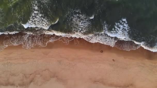 Vista aérea Um vídeo de uma praia tropical ao pôr-do-sol mostrando imagens aéreas à noite de ondas verdes espumantes do oceano batendo na costa. Vista superior sem pessoas — Vídeo de Stock