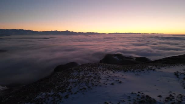 Shooting drone. Winter sunset on top of mountain covered clouds. North Caucasus. — Stock Video