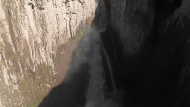 Aerial view of a huge waterfall from a sheer cliff in the Caucasus. Close shot of a large stream of water in the mountains. Caucasian Iceland — ストック動画