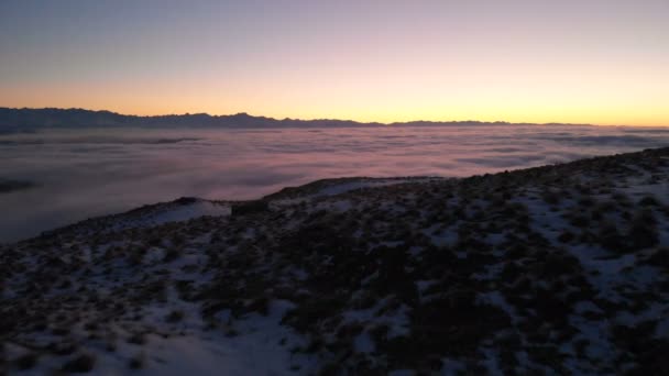 Shooting drone. Winter sunset on top of mountain covered clouds. North Caucasus. — Stock Video