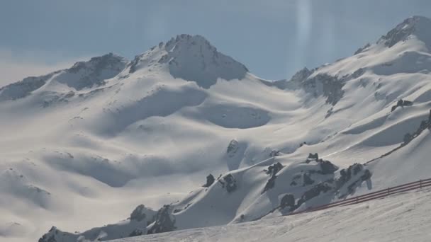 Climb up on cable car. Snowy mountains, ski run. Sunny day. North Caucasus. — Stock Video