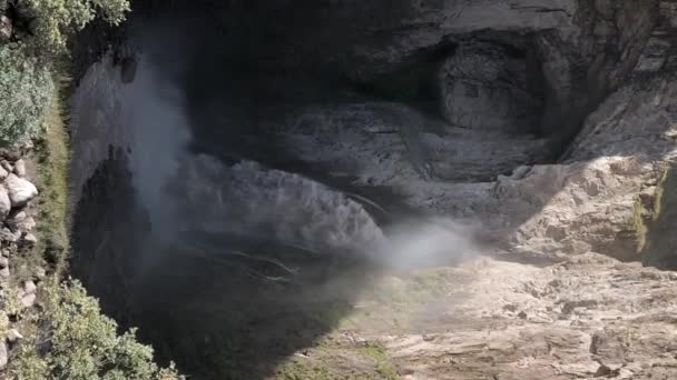 Vertical video of a speed ramp is a large epic waterfall among high cliffs in slow motion in the North Caucasus or in Iceland. Vertical video for mobile applications — Stock Video