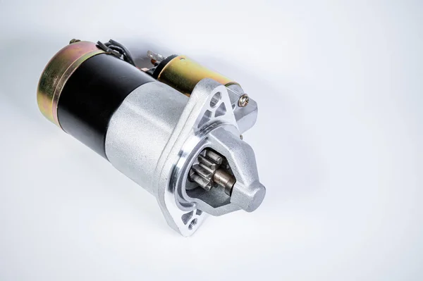 Starter of an internal combustion engine New Spare part for car on a gray background — 스톡 사진
