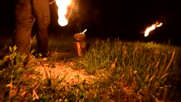 Close-up. Camera follows man in the dark with a burning ball, poi. Fire show — Stock Video