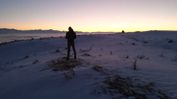 Man controls shooting drone. Beautiful snowy landscape. Winter, Caucasus, sunset — 图库视频影像