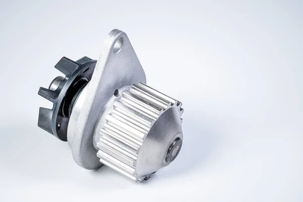 New metal automobile pump for cooling the engine of a water pump on a gray background. The concept of new spare parts for the car engine — 스톡 사진