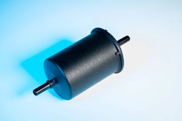 New fuel filter in a black plastic housing for diesel and gasoline engines on a gray background