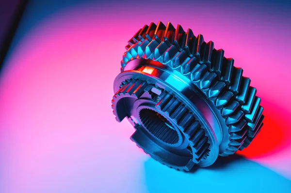 New metal gears spare parts for gearbox in two colors red and blue. Conceptual image of the mechanical elements of the transmission