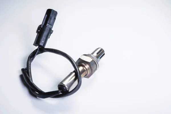 Der Sauerstoffsensor ist ein neuer Lambdasensor. Ersatzteile am Auto auf grauem Gradientenhintergrund — Stockfoto