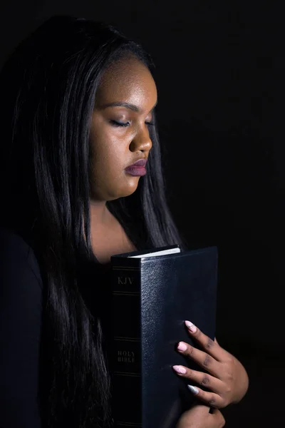 Jeune fille tenant la Bible près de son cœur — Photo