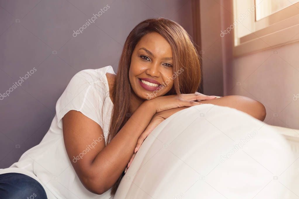 Young Lady Sitting And Smiling By The Window