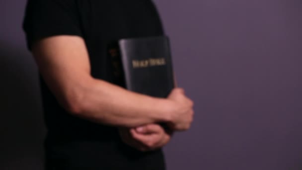 Man Holding Holy Bible Close His Chest — Stock Video