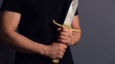 Young Athletic Man Holding His Sword