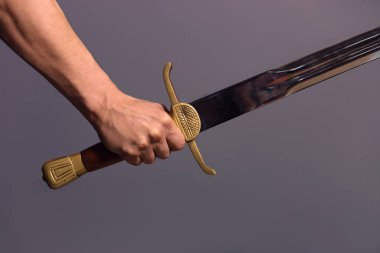 Young Athletic Man Holding His Sword