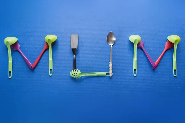 Palavra Mãe Soletrada Com Utensílios Cozinha Fundo Azul — Fotografia de Stock