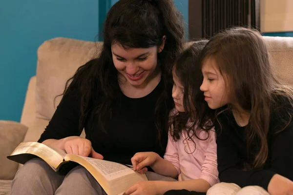 Młoda Matka Czytająca Pismo Święte Swoim Małym Dziewczynkom — Zdjęcie stockowe