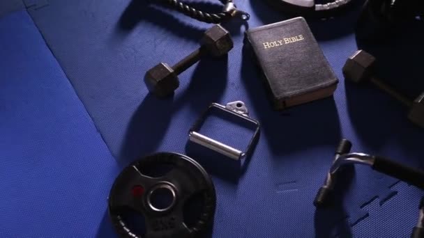 Bible Surrounded Various Gym Equipment — Stock Video