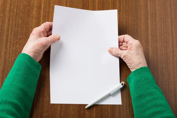 Old hands with blank paper — Stock Photo, Image