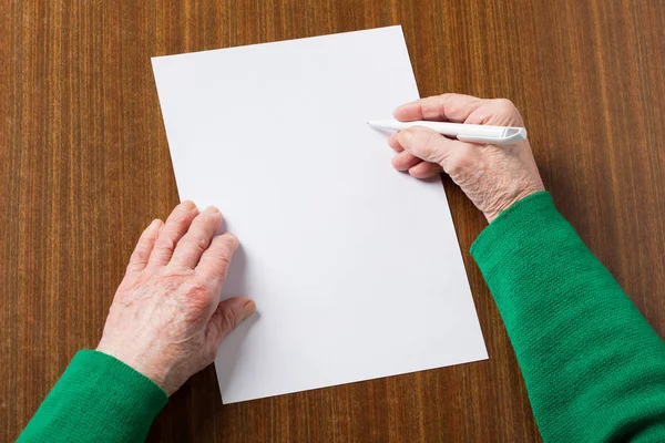 stock image Old hands with blank paper