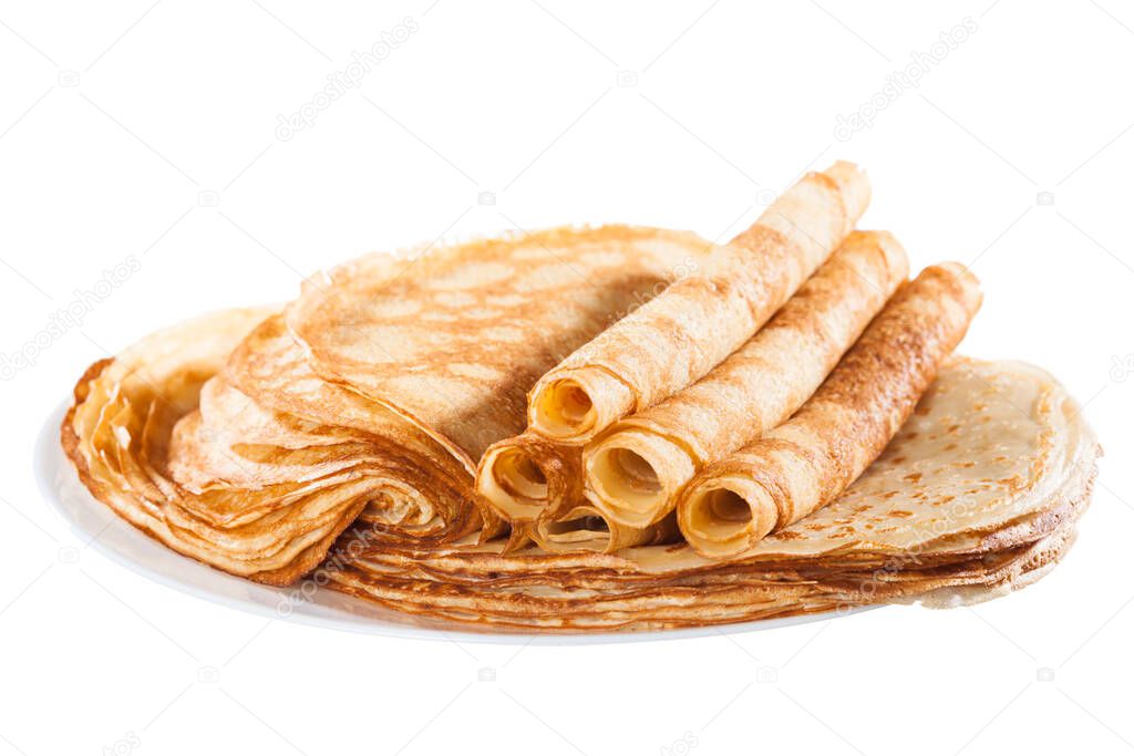 Thin pancakes stacked on a plate in a pile