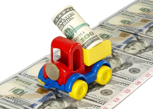 Caminhão brinquedo na estrada a partir de dinheiro — Fotografia de Stock