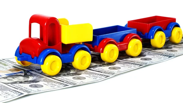 Truck toy on the road from money isolated on white background — Stock Photo, Image