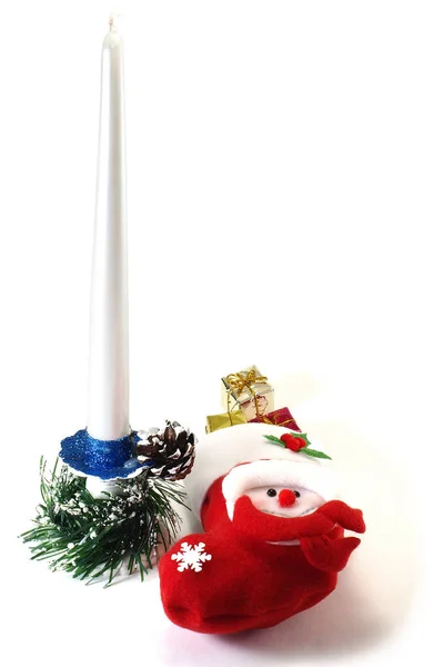 Candle on a candlestick, boot with gifts and pine cone isolated — Stock Photo, Image