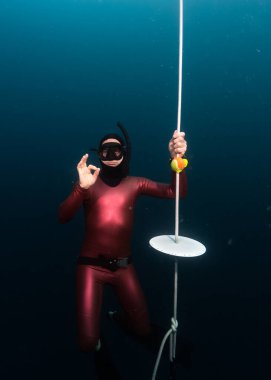 Serbest dalgıçlar eğitim çizgisinin sonunda derinlerde asılı 