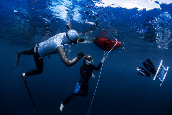Free diver ascending along the rope