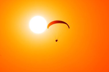 Paraglider güneşe karşı uçar