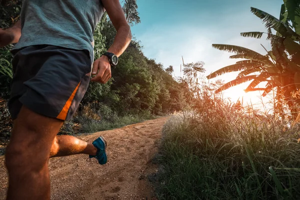 Homem Atlético Corre Uma Estrada Tropical Rural Durante Pôr Sol — Fotografia de Stock